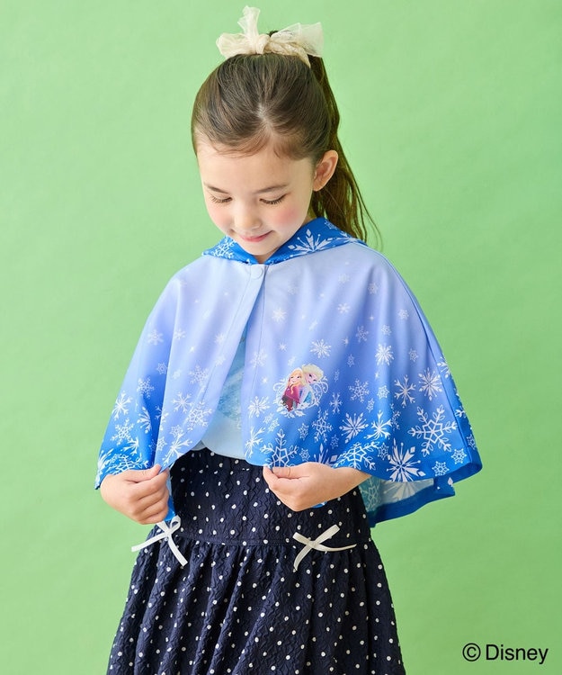 Child wearing a blue Elsa poncho with snowflakes and an Elsa graphic.