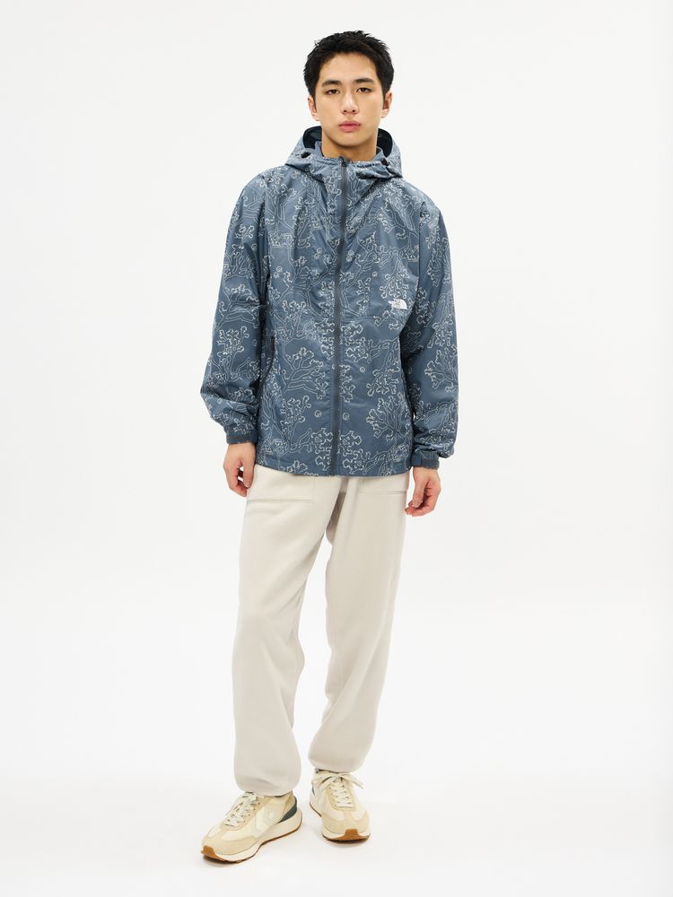 Male model wearing the men's embroidered compact nylon jacket with hood and front zipper, shown full-length against a white background.