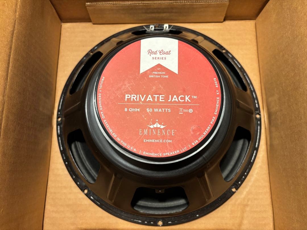Back view of the Eminence PRIVATE JACK 8Ω 50W speaker showing its red label inside a cardboard box.