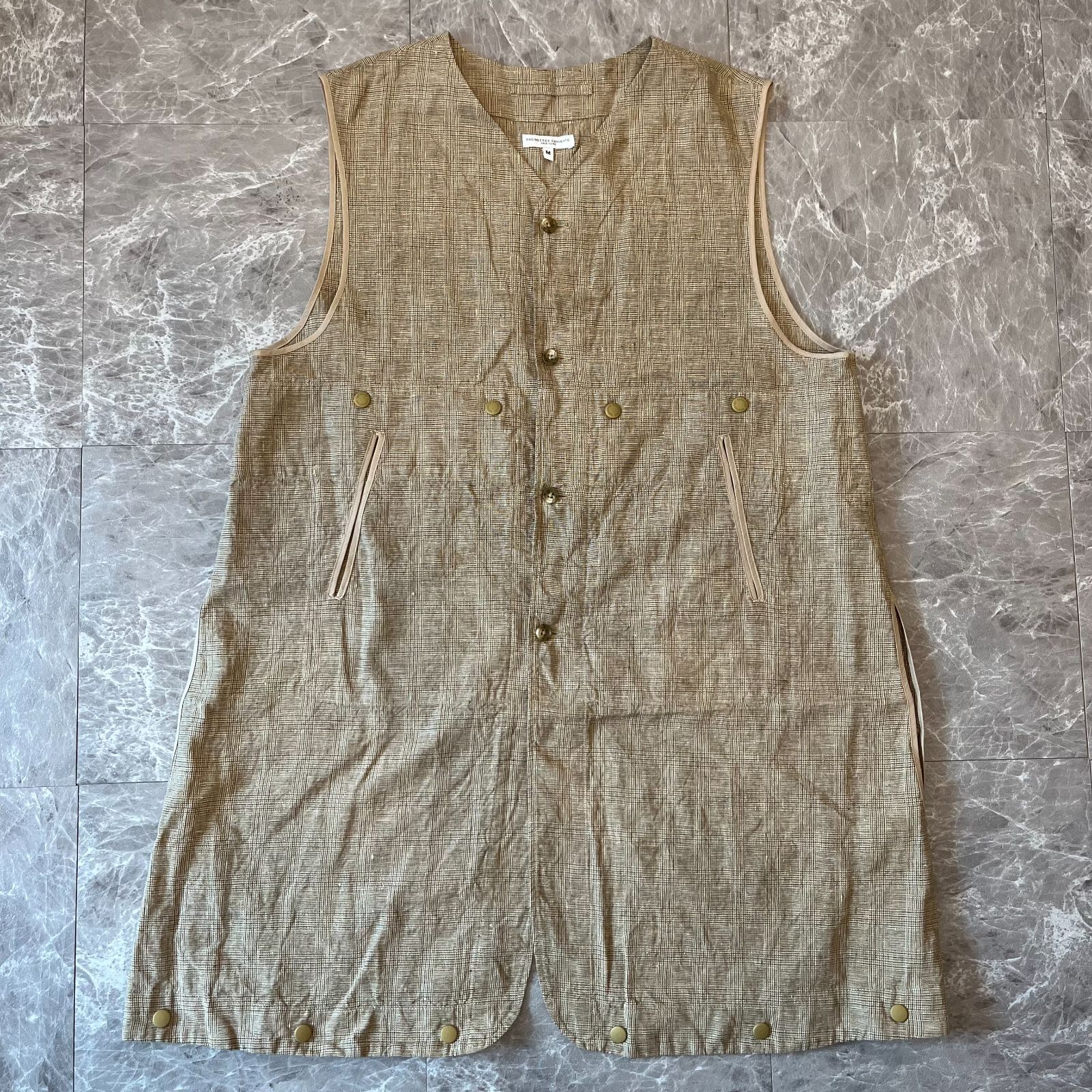 Beige linen Glen plaid liner vest laid flat, front view showing buttons and pockets.