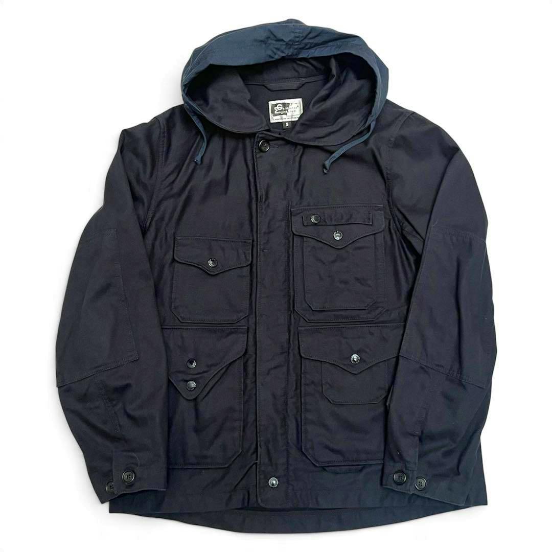 Engineered Garments Cruiser jacket laid flat on a white background, showing a hood, four front flap pockets, and button closures.
