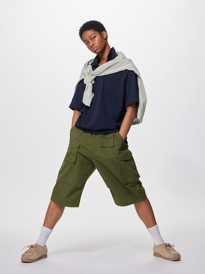 A model wearing the men's olive-green utility shorts.