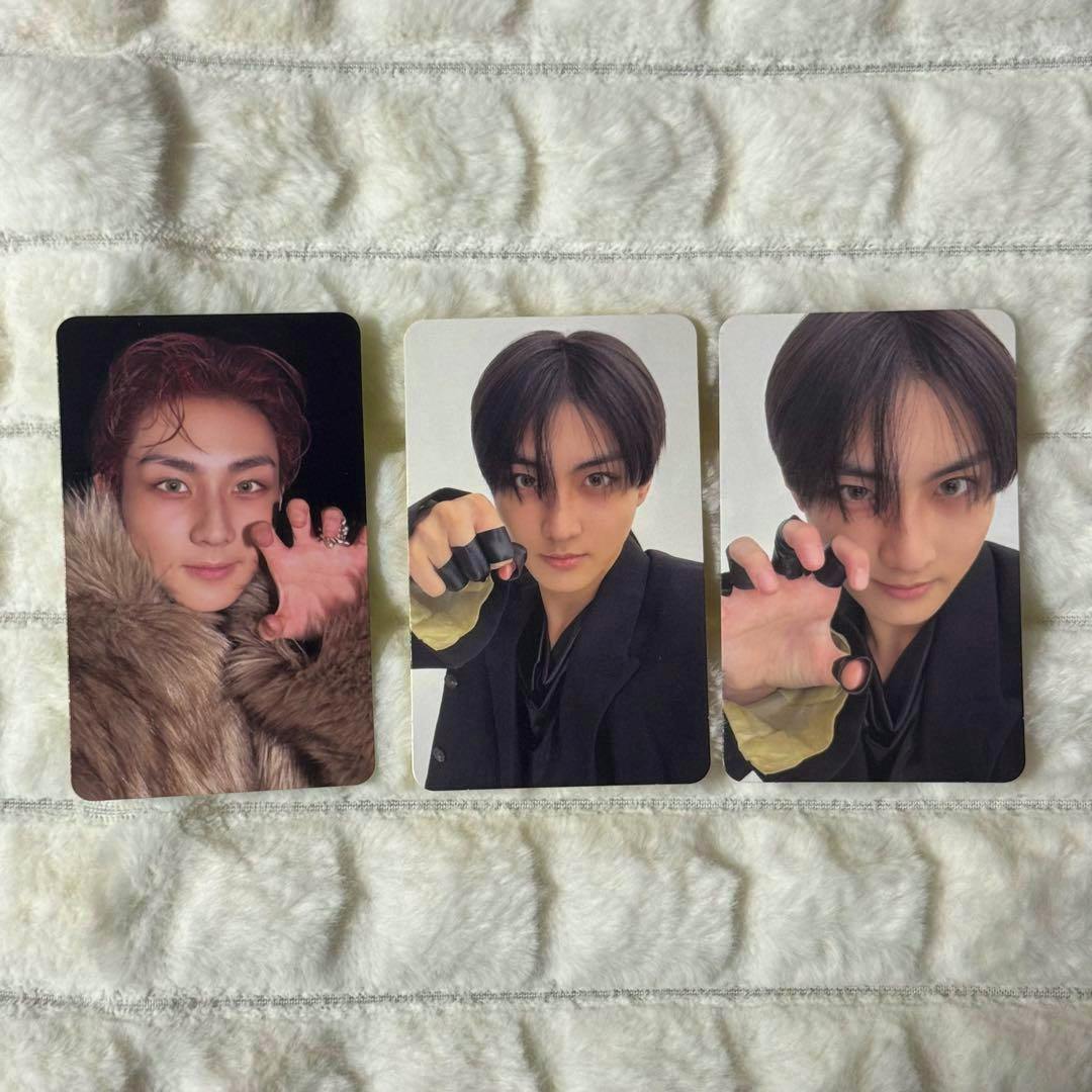 Three photocards from enhypen THE SIN : BLISS showing the front photos of the cards laid on a white textured cloth.