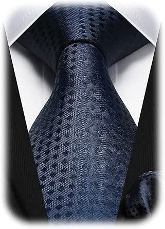 Close-up of a navy textured necktie tied in a knot worn with a white dress shirt and dark suit, with a matching handkerchief visible.