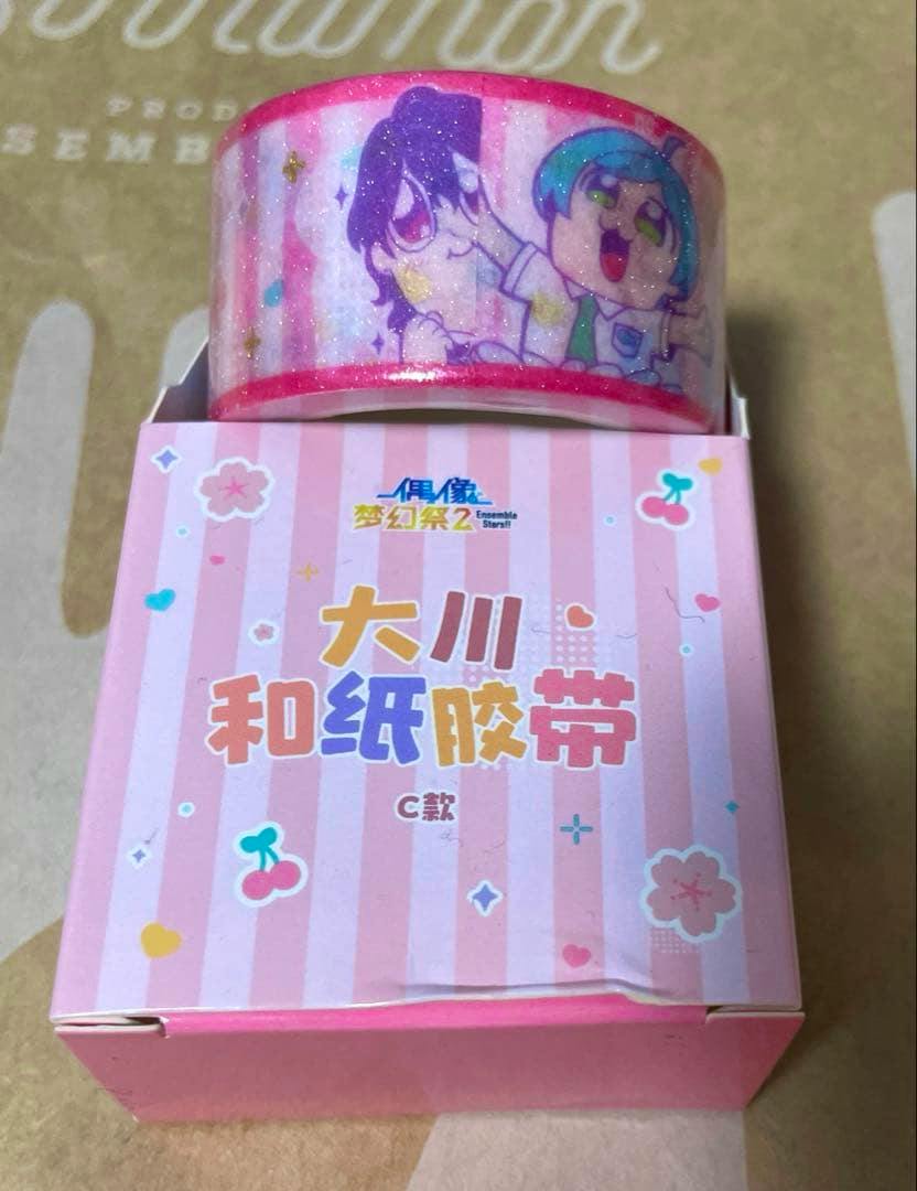 Roll of anime-patterned masking tape displayed on top of its pink striped box.