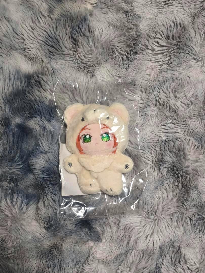A small “一緒に暮らす” plush of 葵ゆうた (あんスタ) in a bear costume sealed in plastic on a gray fuzzy background.