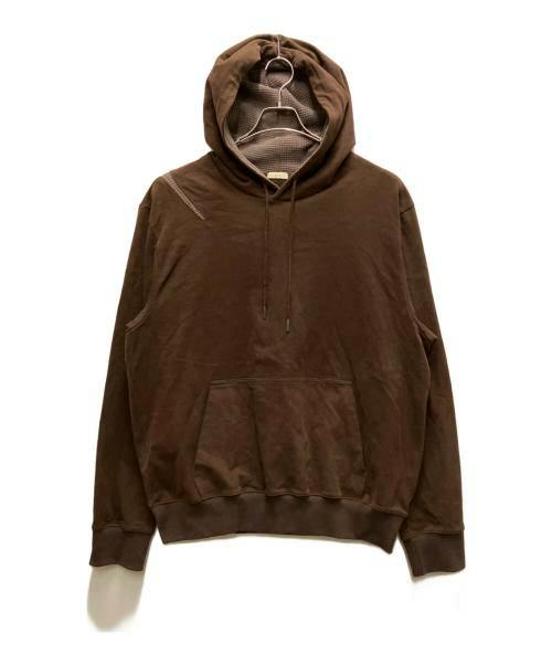 Brown pullover hoodie hanging on a hanger against a white background.