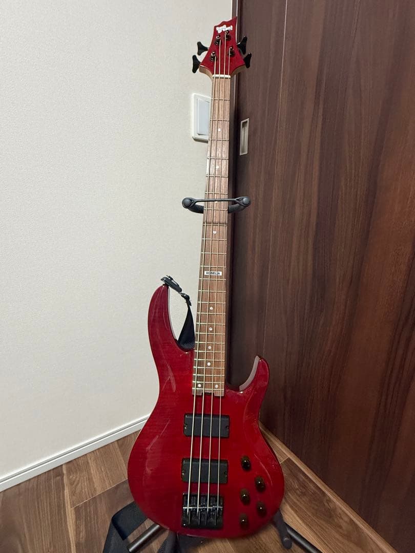 Red ESP × BanG Dream Imai Risa model bass guitar standing on a guitar stand against a wall.
