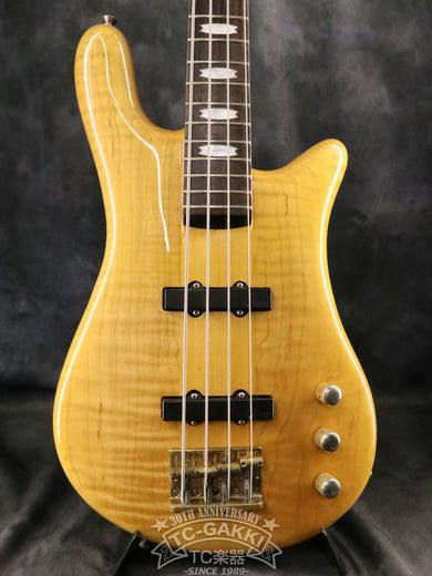Front view of the ESP NS-type bass guitar in natural wood finish showing the body, pickups, bridge, control knobs, and part of the neck.
