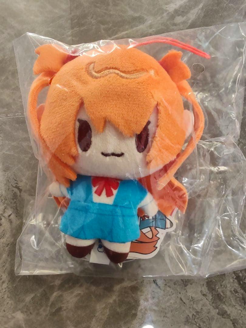 Front view of an Asuka (EVA) plush mascot wearing a blue school uniform inside a clear plastic bag.