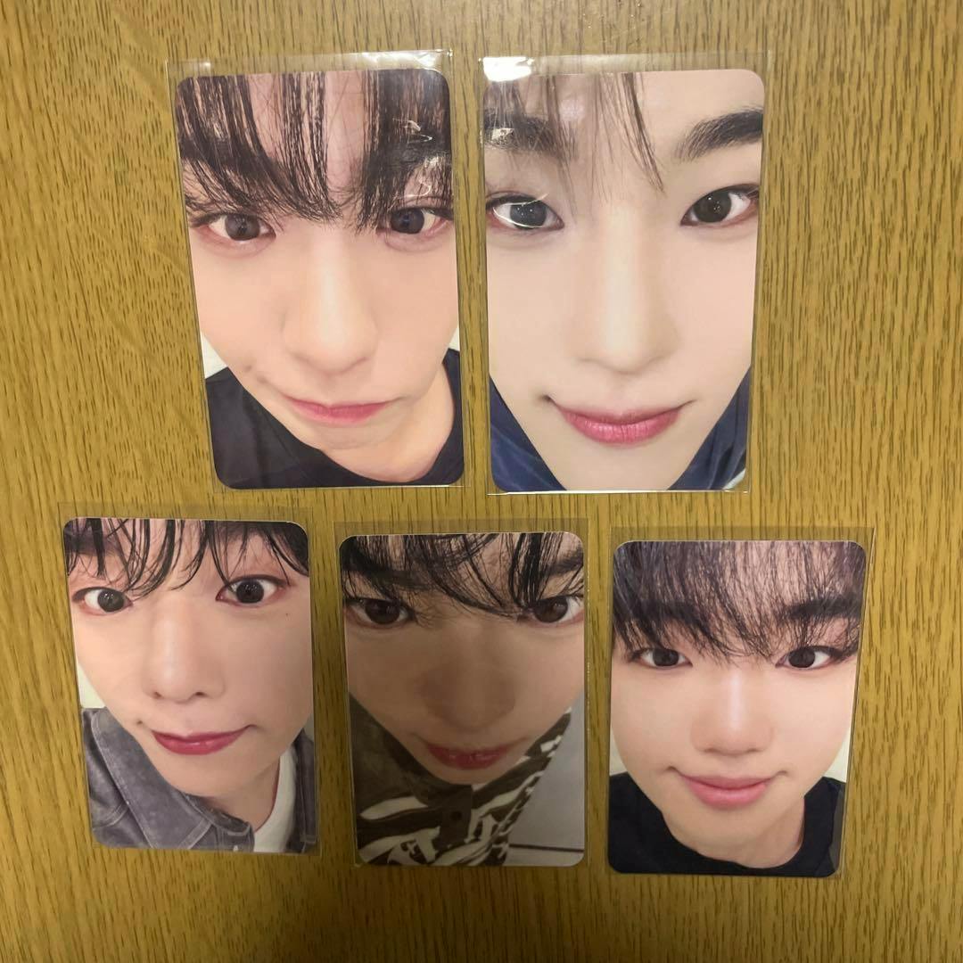 Five EVNNE "Backtalk" photocards laid out on a wooden surface showing close-up face photos.