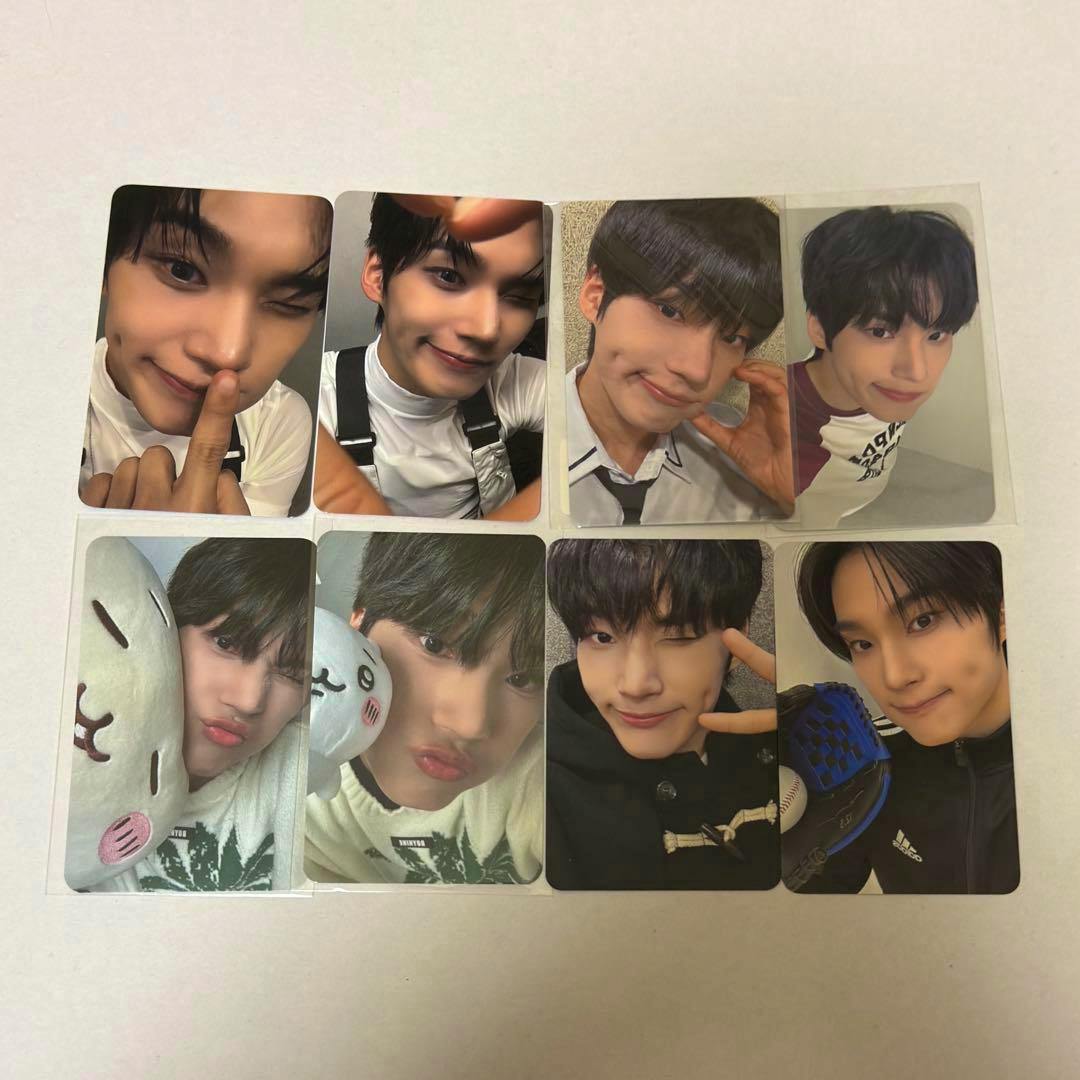 Photo of multiple EVNNE Park Hanbin photocards arranged on a white surface.