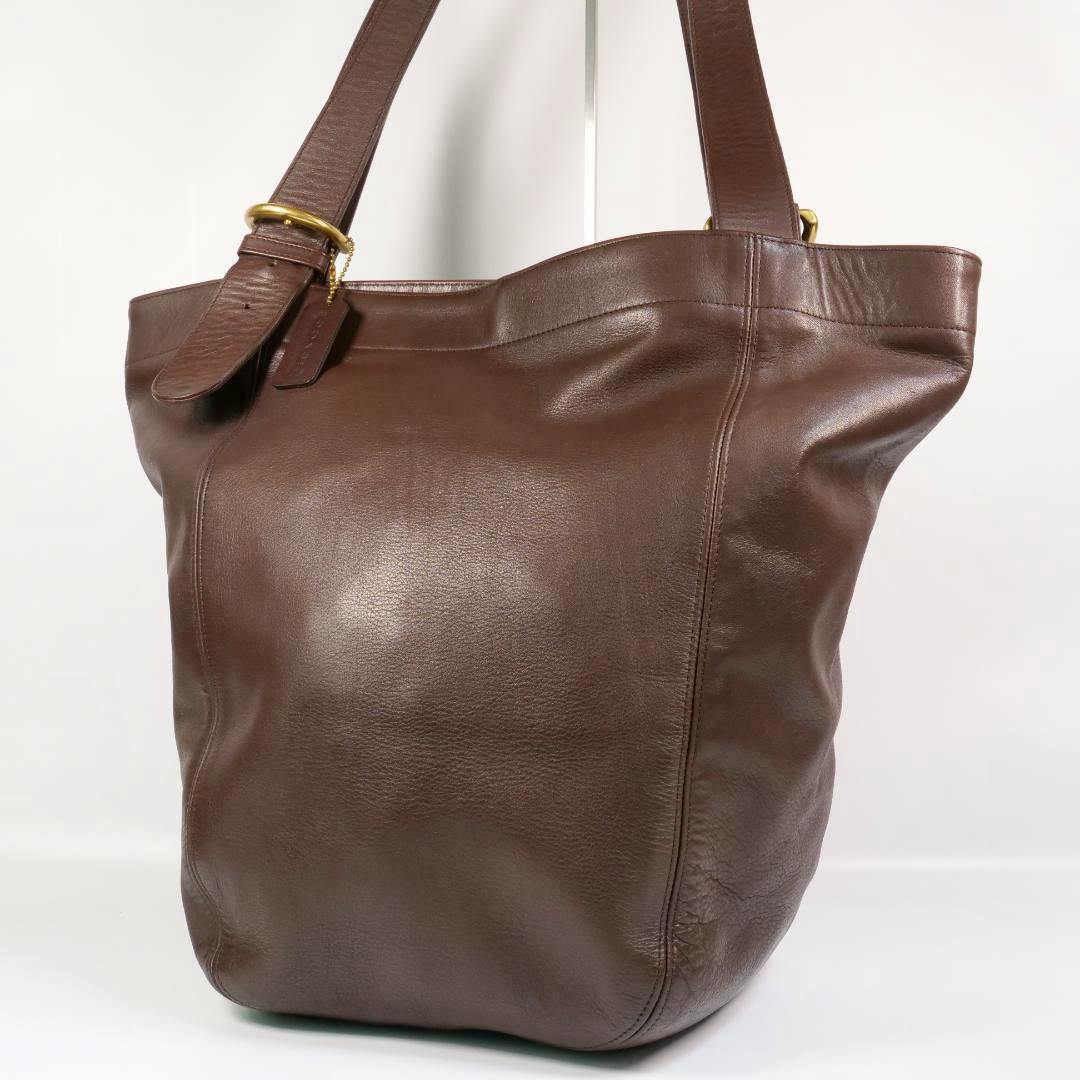 Brown leather Old Coach tote shoulder bag shown from the front with straps and a leather hang tag.