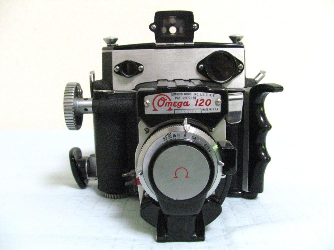 Front view of the Omega 120 film camera showing the lens, shutter assembly, and Omega nameplate.