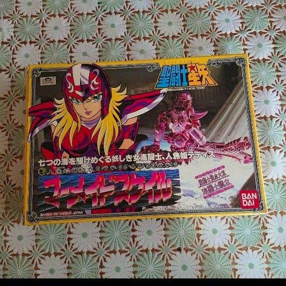 Front of the product box for a Saint Seiya Mermaid Scale cloth figure, showing character artwork and the Bandai logo.