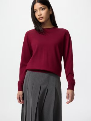 Model wearing a long-sleeve merino sweater in burgundy.
