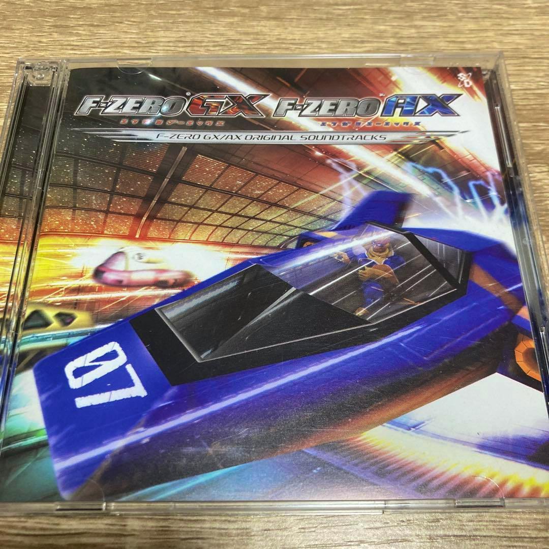 Photograph of the F-ZERO GX / F-ZERO AX original soundtracks CD jewel case front cover showing a blue racing craft and the title logo.