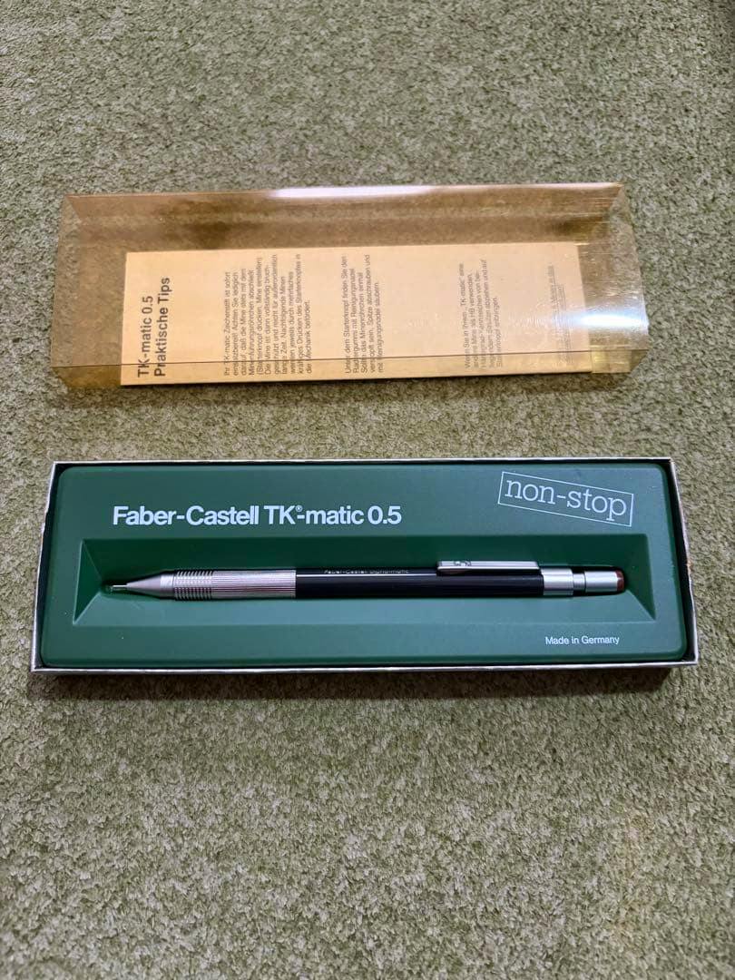 Faber-Castell TK-matic 0.5 mechanical pencil shown in its green presentation box with a clear plastic lid.