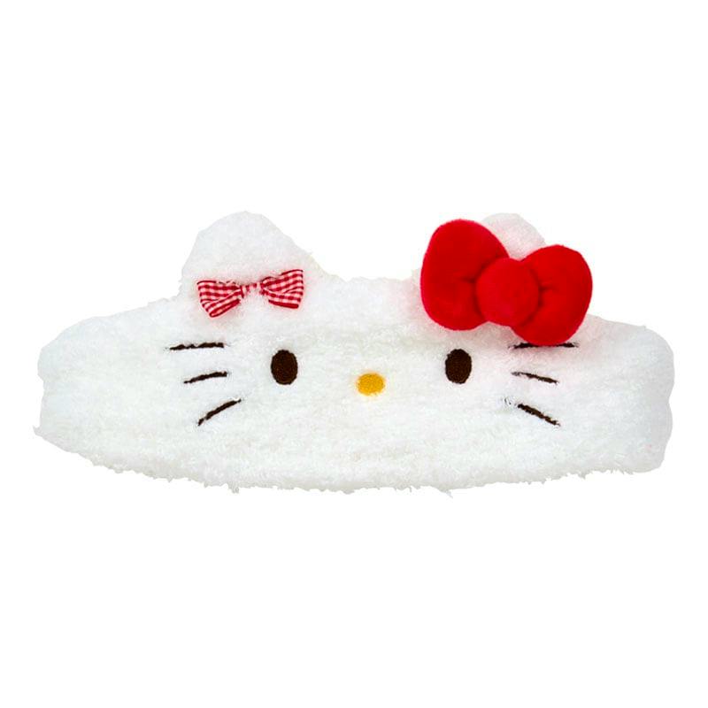 A white face-shaped fluffy hair band with embroidered brown eyes, a yellow nose, whiskers, and two red bows.