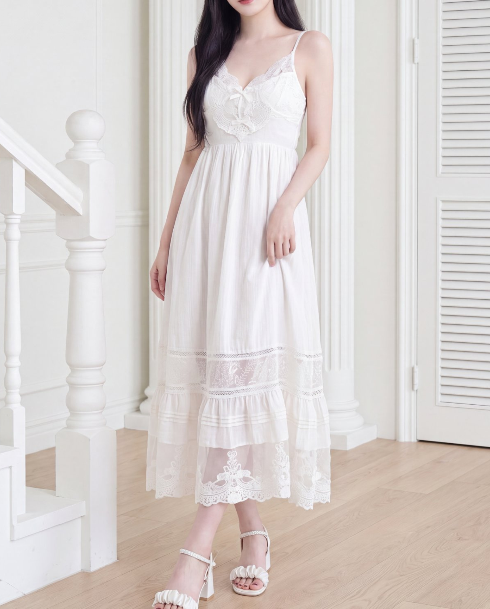 Model wearing the women's long lace cami dress (rayon) standing indoors by a staircase.
