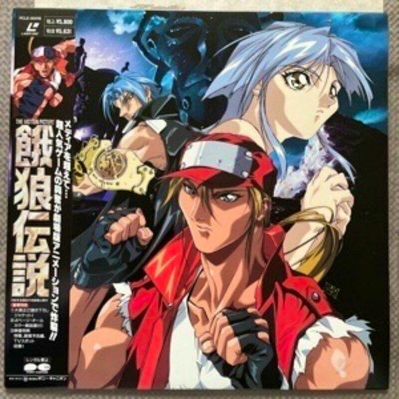 Cover art of the Japanese Laser Disc release of "The Motion Picture 餓狼伝説" featuring anime character illustrations and an obi strip.