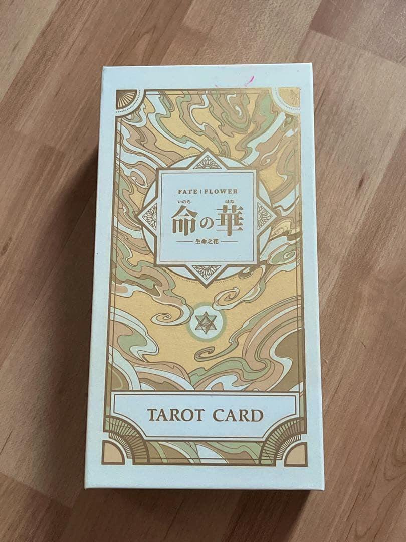 Photo of the FATE FLOWER 命の華 tarot card deck box front showing decorative packaging and the words “TAROT CARD.”