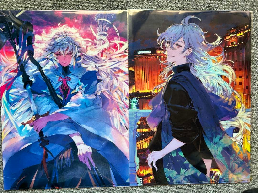 Two FGO clear files showing illustrated Merlin designs laid side by side on a gray carpet.