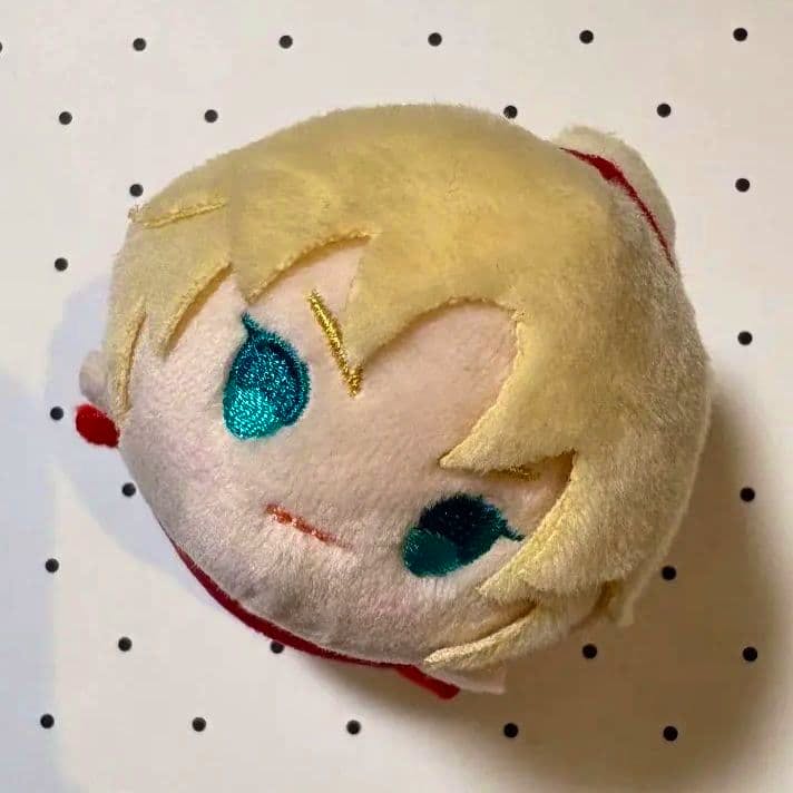 Close-up of a Fate/Grand Order (FGO) Modred mochi mochi mascot plush showing the embroidered face and blond hair.