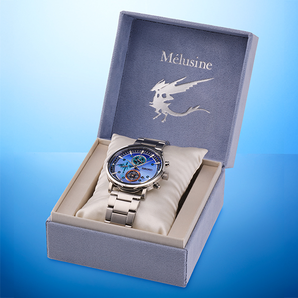A Melusine model wristwatch from Fate/Grand Order in a silver metal bracelet, displayed on a cushion inside an open presentation box with “Mélusine” printed on the lid.