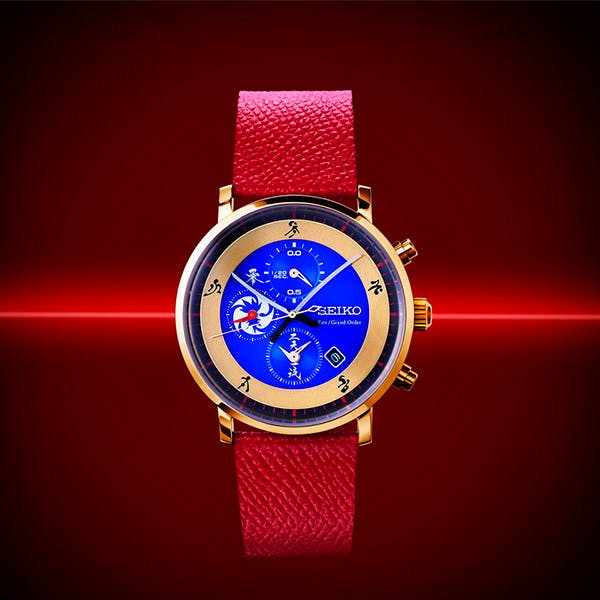 Front view of the Fate/Grand Order Saber (Miyamoto Musashi) wristwatch with a blue dial, gold case, and red leather strap.