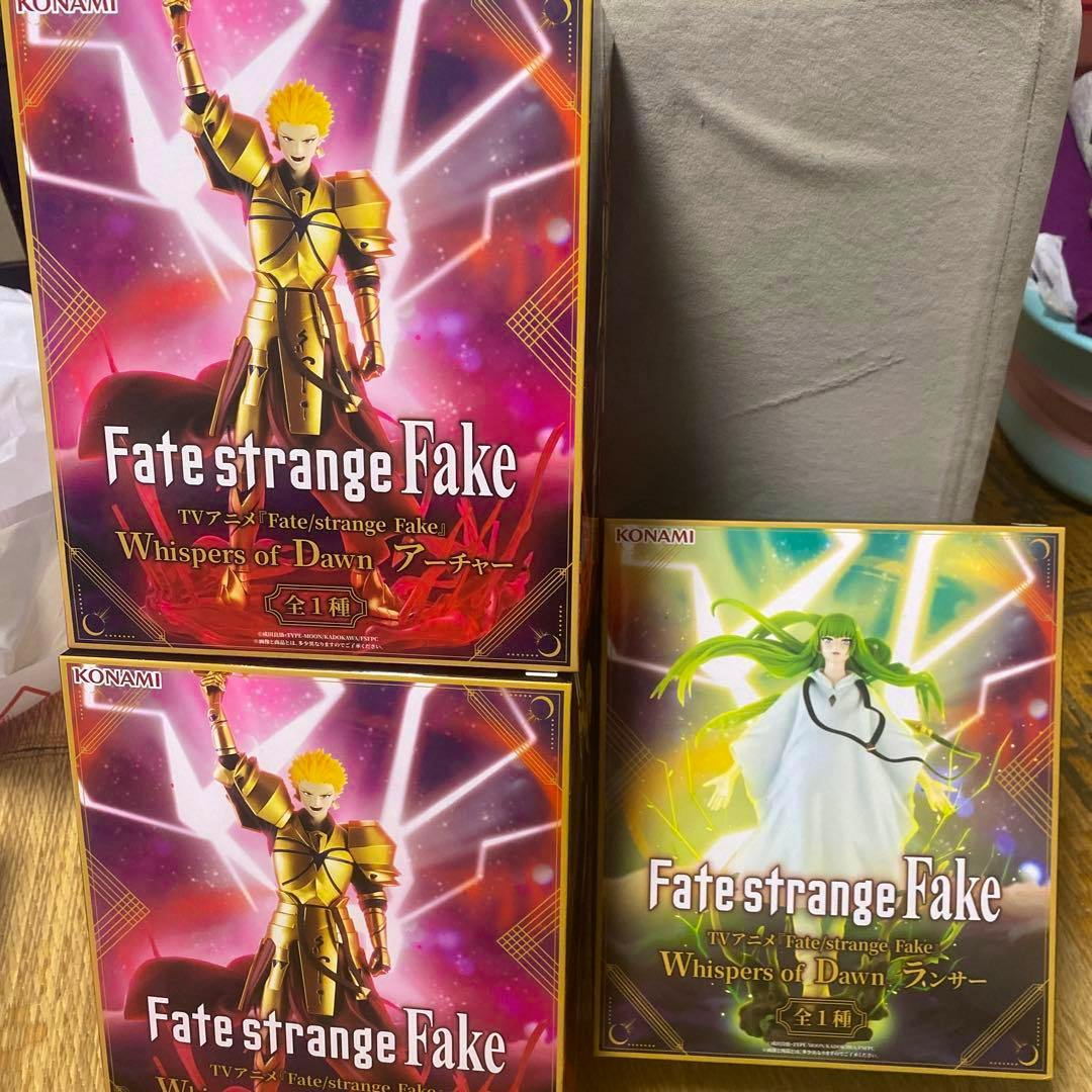 Three boxed Fate/strange Fake figure packages arranged together, showing two Archer boxes and one Lancer box.