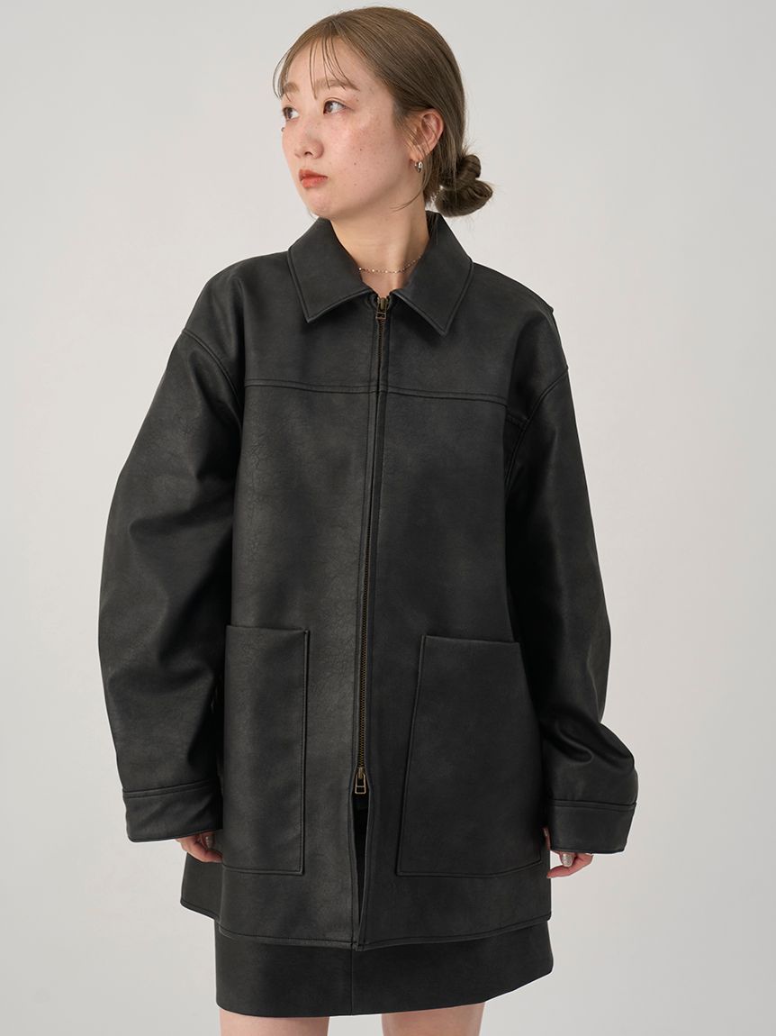 Front view of a black synthetic leather men's double-zip jacket worn by a model.