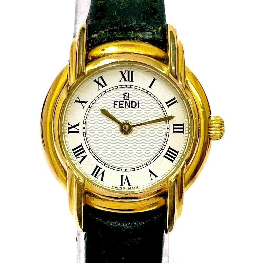 Close-up of the FENDI women's quartz wristwatch showing a white dial with Roman numerals, gold-tone case, and black leather strap.