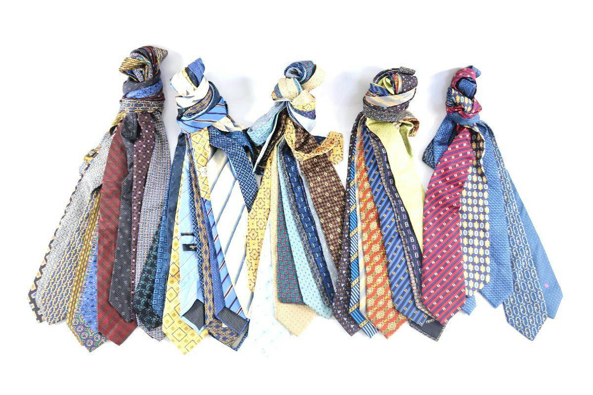 Several patterned silk Fendi neckties knotted at the top and fanned out on a white background.