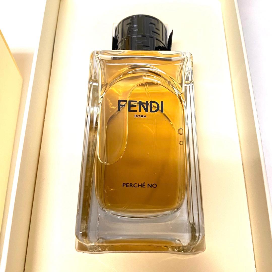Close-up of a FENDI Perché No perfume bottle with amber liquid inside its box.