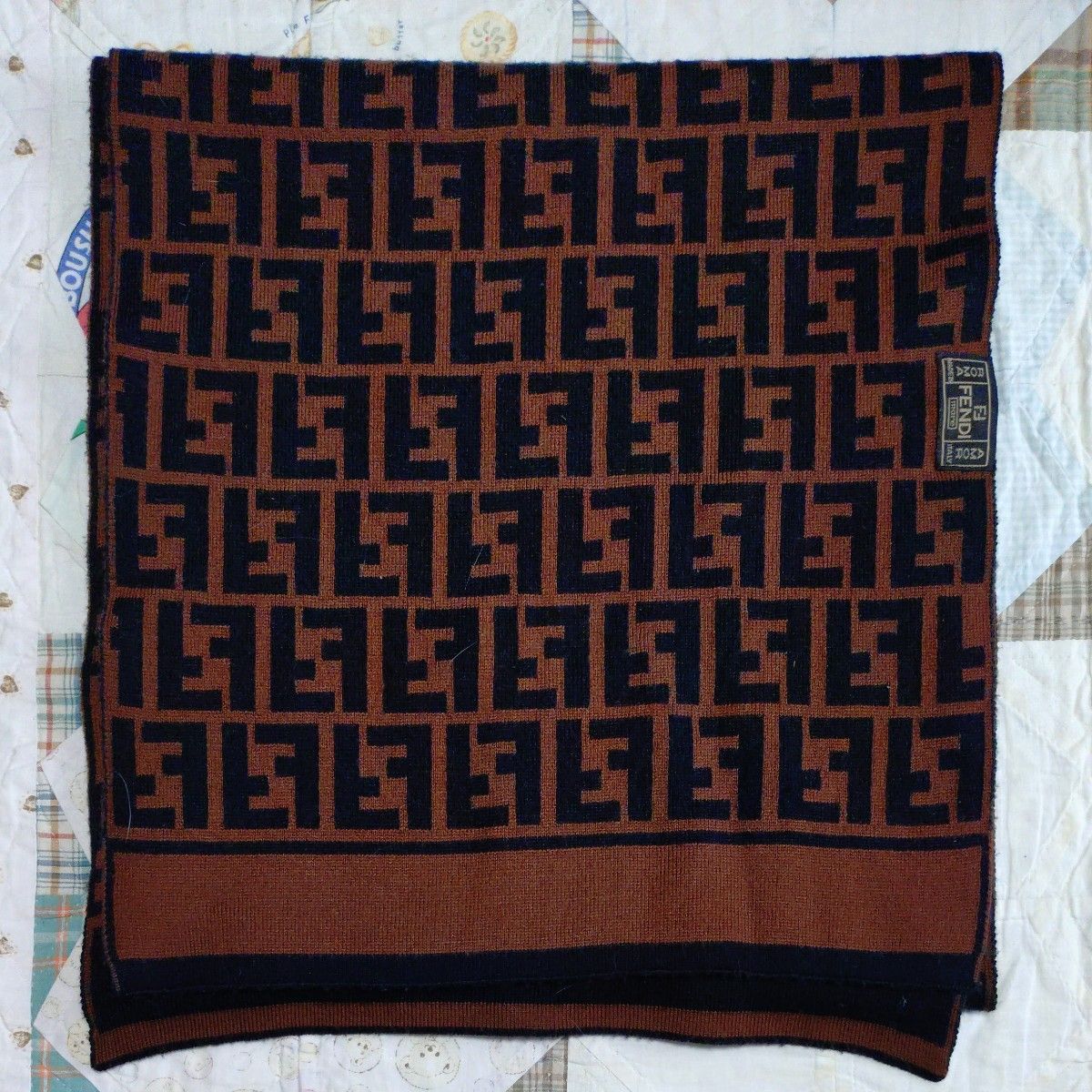 Brown and black FENDI Zucca-pattern scarf laid flat with visible brand label.