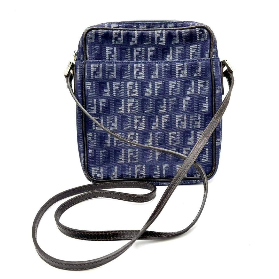 Front view of a blue FENDI denim shoulder bag sacoche with FF monogram and a long leather strap.