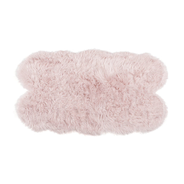 Top-down view of a light pink fluffy acrylic rug shown in a cloud-like shape on a white background.
