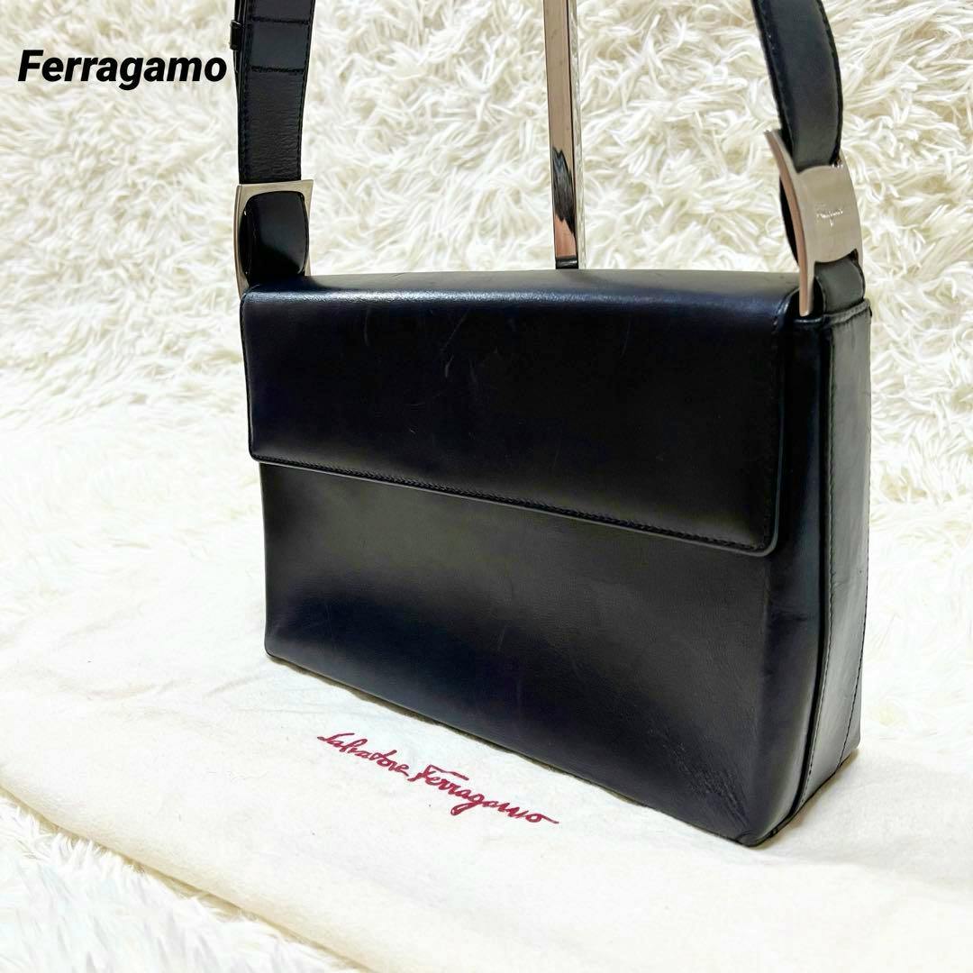 Black Ferragamo leather one-shoulder flap handbag shown on a Salvatore Ferragamo dust bag.