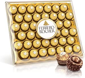 A clear plastic box of Ferrero Rocher milk chocolate hazelnut candies in gold wrappers with two unwrapped chocolates displayed in front.