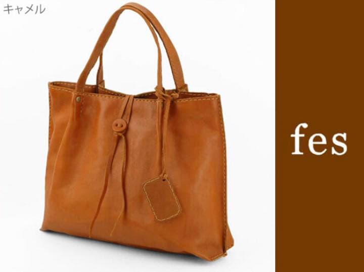 Camel-colored cow leather tote handbag on a white background.