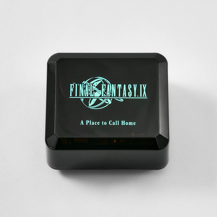 Top-down photo of a black music box with "FINAL FANTASY IX" and "A Place to Call Home" printed on the lid.