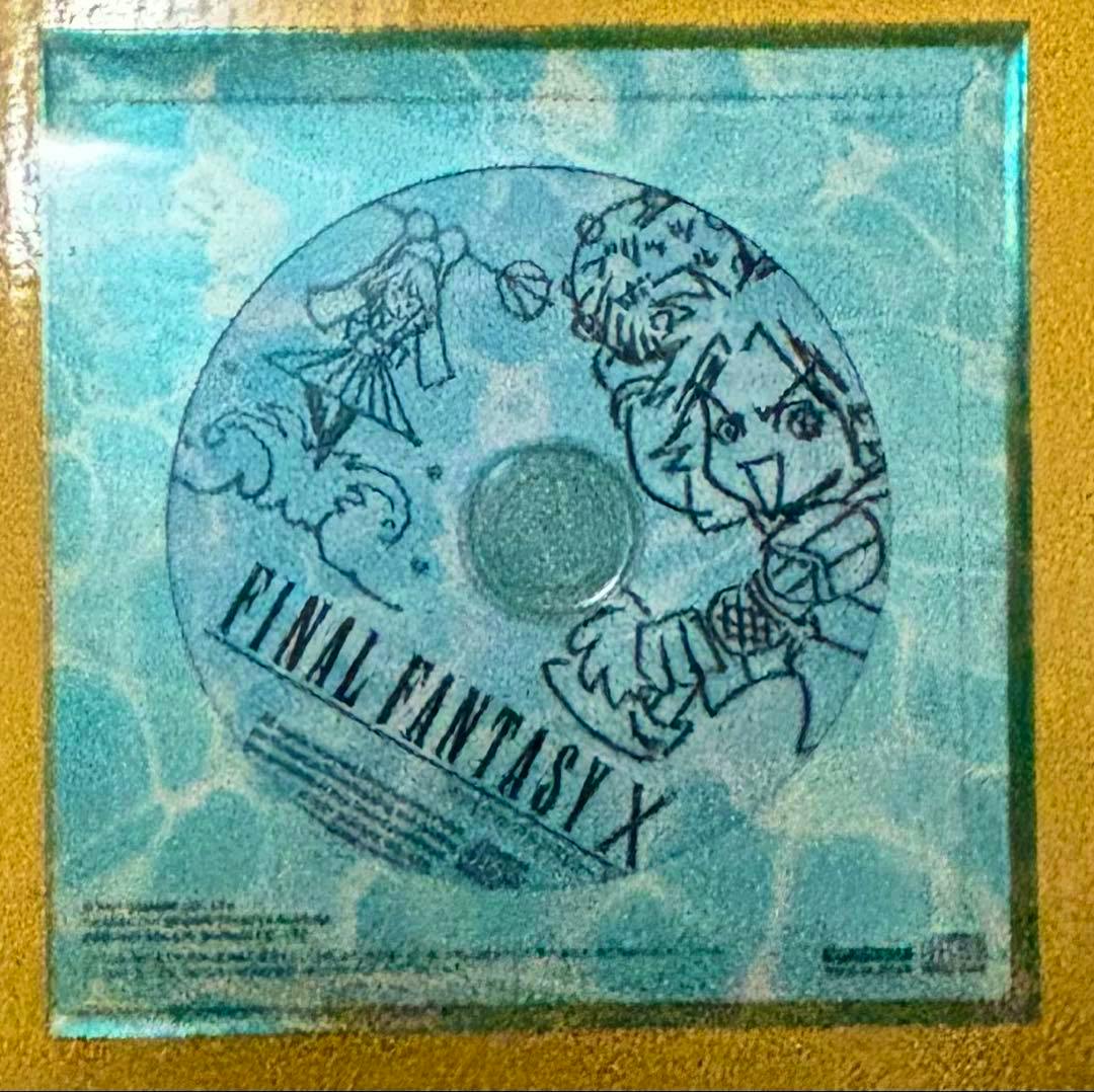 Photo of the FINAL FANTASY X CD showing the disc with blue illustrated artwork and the title printed on it.