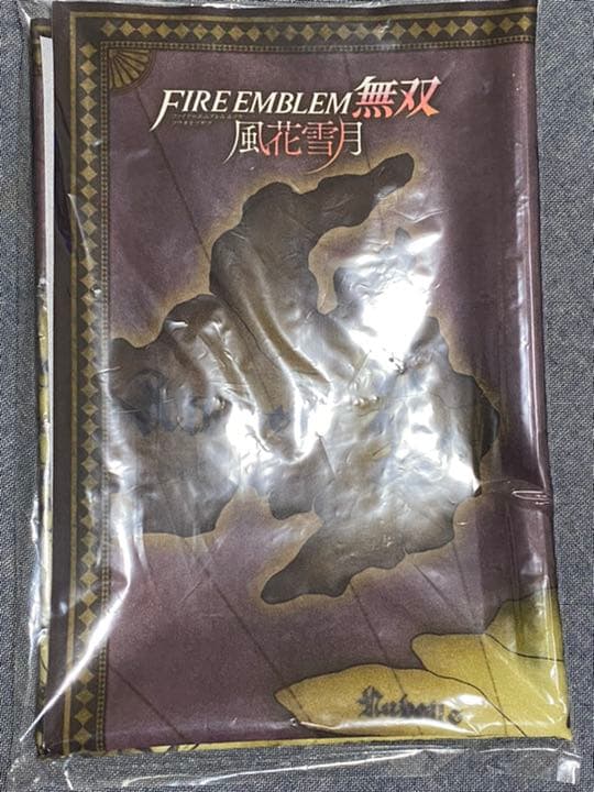 Packaged folded table cloth showing a map of Fódlan and a FIRE EMBLEM logo.