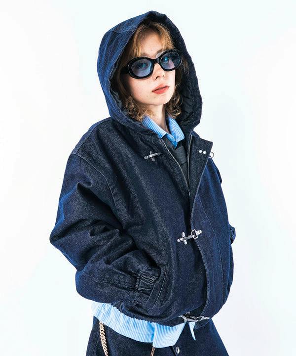 Person modeling a dark hooded cotton sweatshirt jacket with visible metal toggle closures.