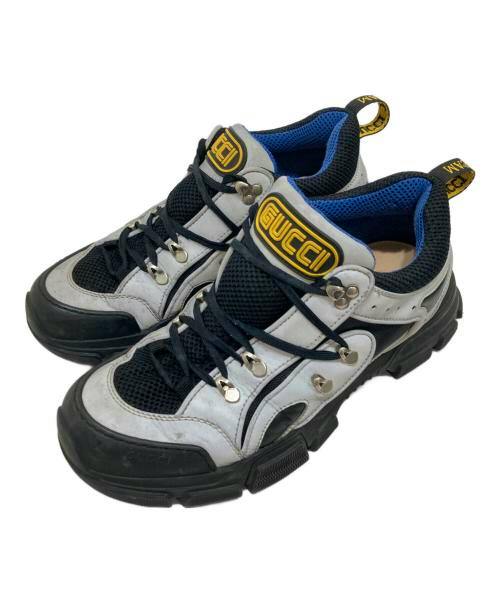 Angled top view of a pair of trekking boots in white, black, and blue.