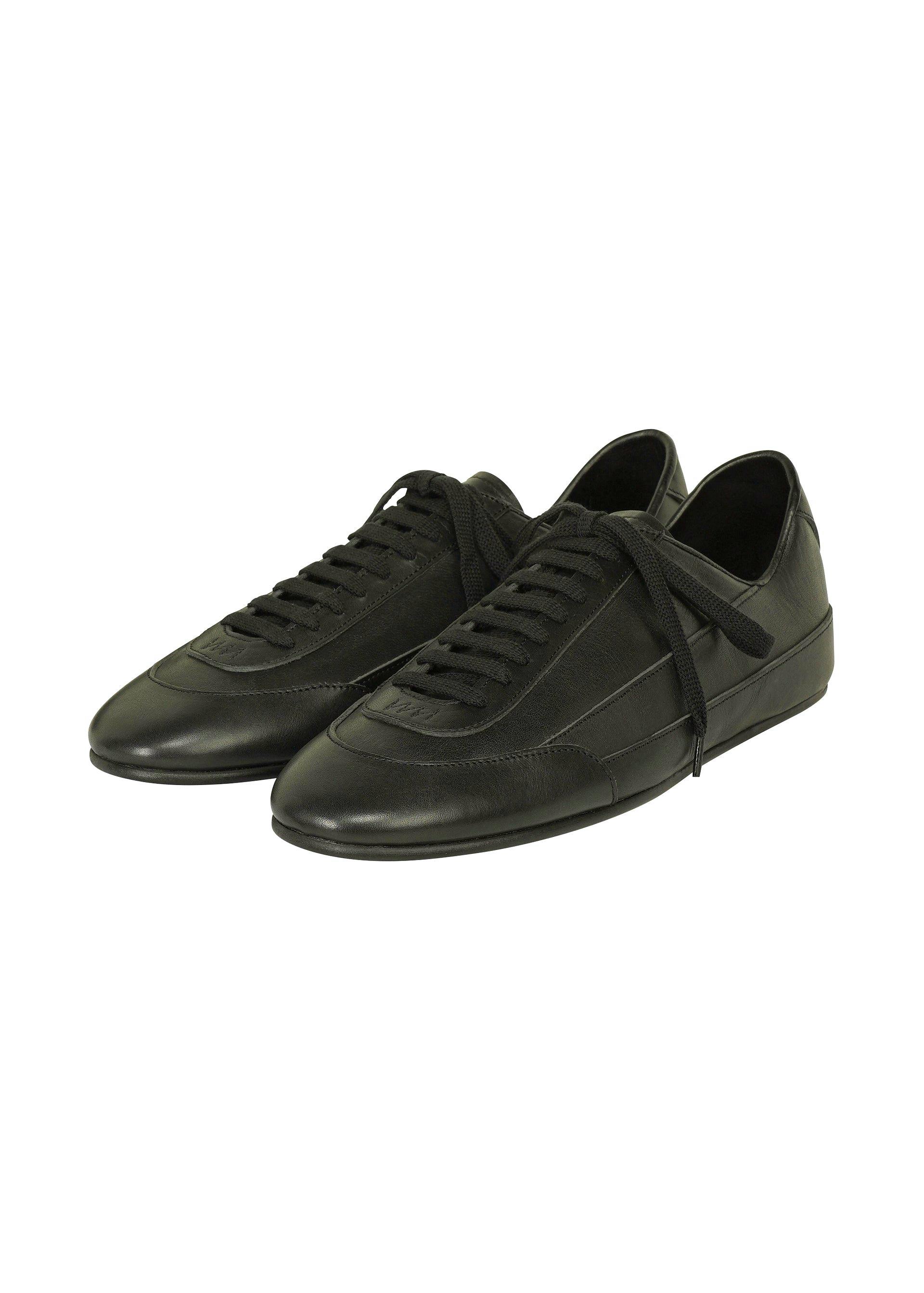 Pair of black leather lace-up shoes photographed on a white background.