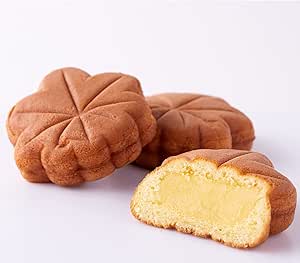 Three fluffy Momiji buns are shown on a white surface, one cut open to reveal custard cream filling.