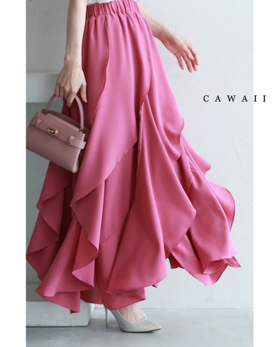 Pink petal-frill women's skirt shown on a model from waist to hem with ruffled layers, handbag, and heels visible.