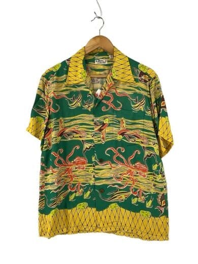 Front view of a green and yellow rayon men's Aloha shirt (size M) with an all-over flying fish pattern hanging on a wooden hanger.